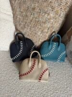 Hermès Baseball Bolide 45 bags in textured Evercolor leather showcase playful contrast-stitched lacing
